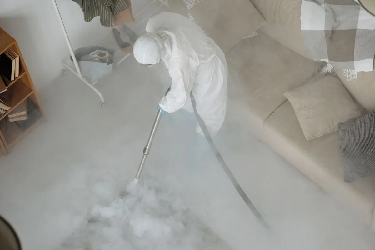 Biohazard cleanup technician in protective equipment, Garden Plain, KS
